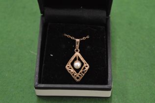 A 9ct yellow gold and pearl pendant and chain.
