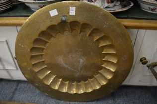 An Eastern engraved brass circular dish.