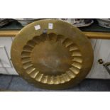 An Eastern engraved brass circular dish.