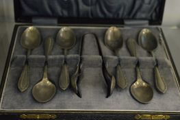 A cased set of coffee spoons and sugar tongs.