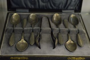 A cased set of coffee spoons and sugar tongs.