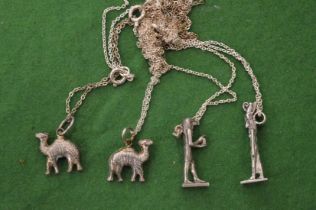 Silver necklaces with Egyptian revival pendants.