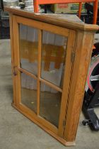 A pine hanging corner cupboard.