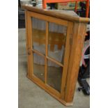 A pine hanging corner cupboard.