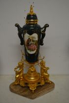 A decorative porcelain and ormolu centre piece with marble base.