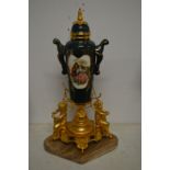 A decorative porcelain and ormolu centre piece with marble base.