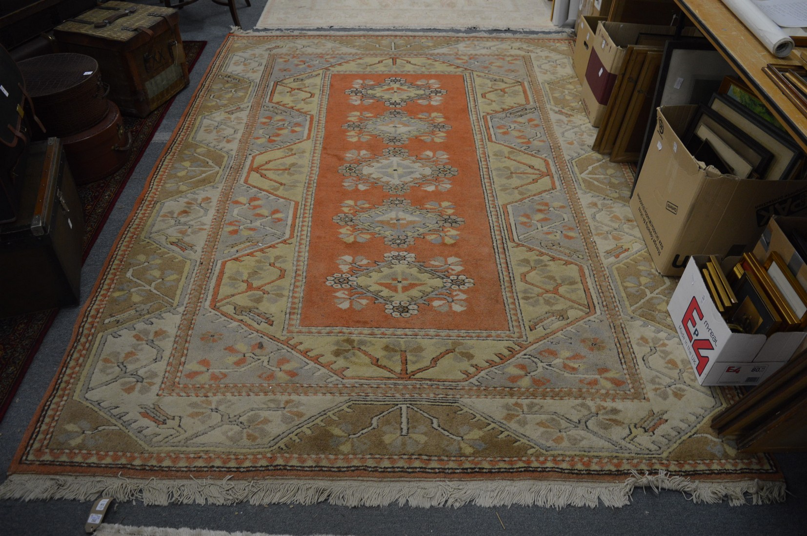 A Persian style carpet, cream and rust ground with stylised decoration 280cm x 200cm.