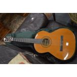 A classical guitar with case.