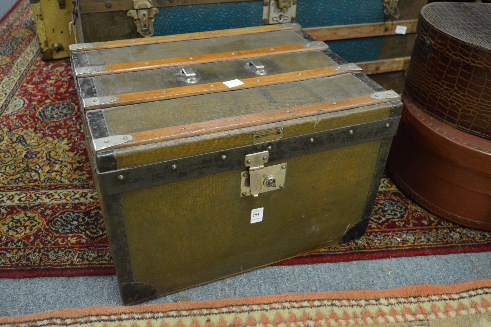 A good small metal and wooden bound travelling trunk.