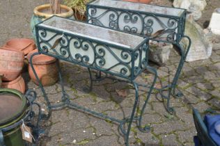 A pair of wrought iron plant troughs.