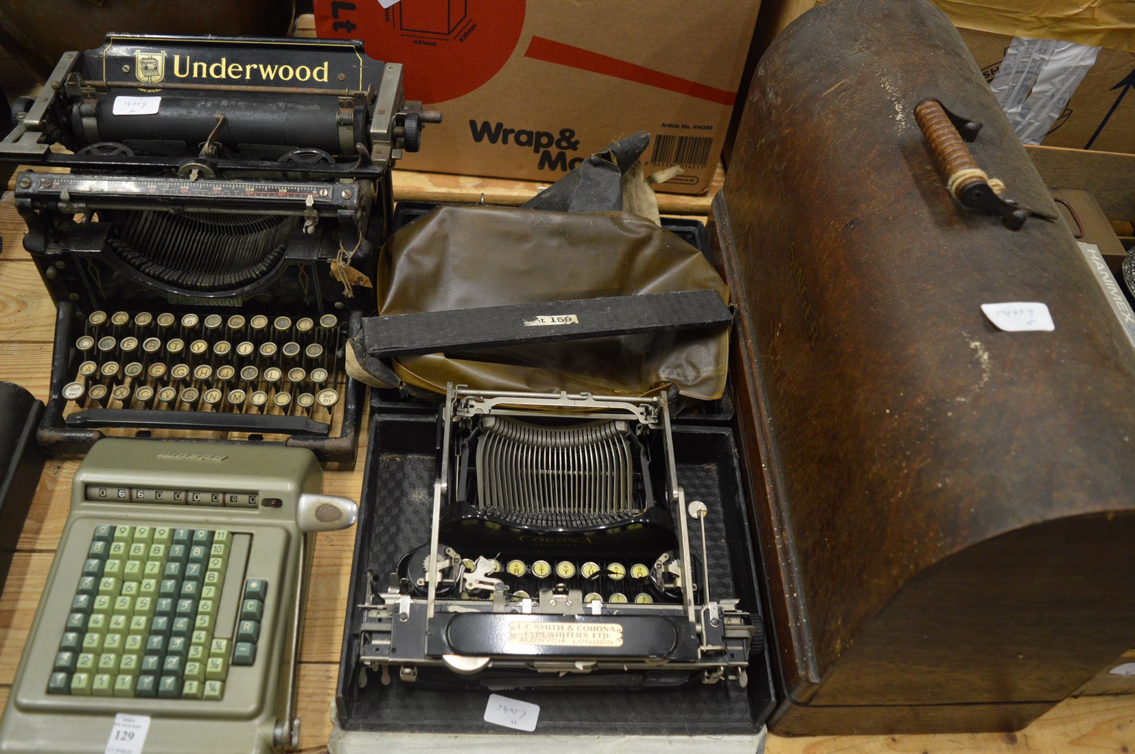 Old typewriters, adding machine and a Singer sewing machine.