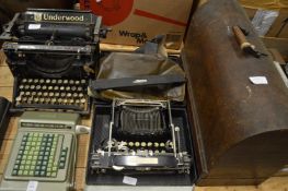 Old typewriters, adding machine and a Singer sewing machine.