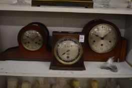 An oak cased desk calendar and two mantle clocks.