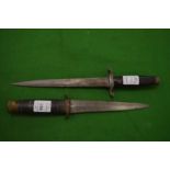 A Taylors Eye Witness dagger together with another dagger/plug bayonet.