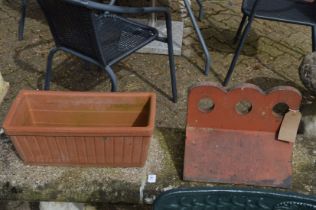 A terracotta ridge tile and a planter.