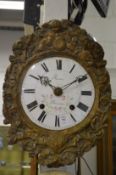 A Continental wall clock with painted enamel dial and embossed brass frame.