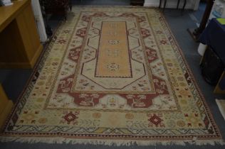 A large Persian style carpet, cream ground with stylised decoration 320cm x 200cm.