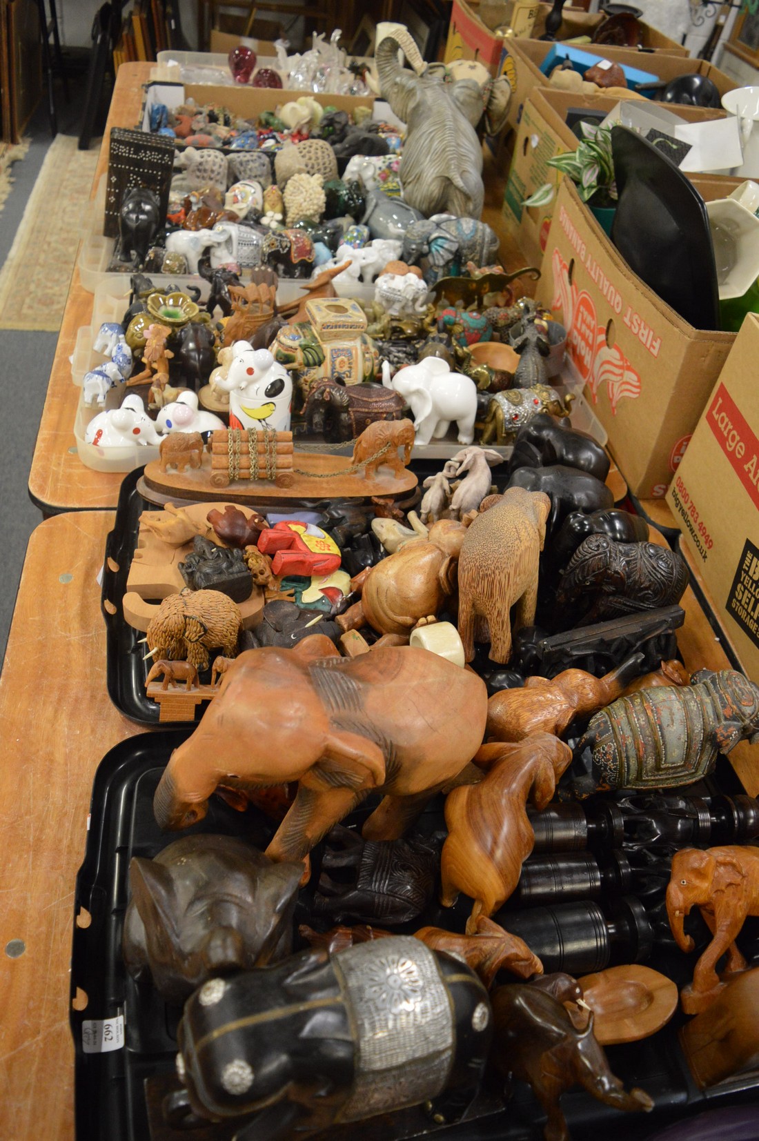 A very large collection of elephants comprising wooden, porcelain, glass and other elements.