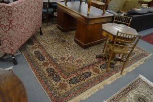 A large Persian style machine made carpet, cream ground with floral decoration 360cm x 265cm.