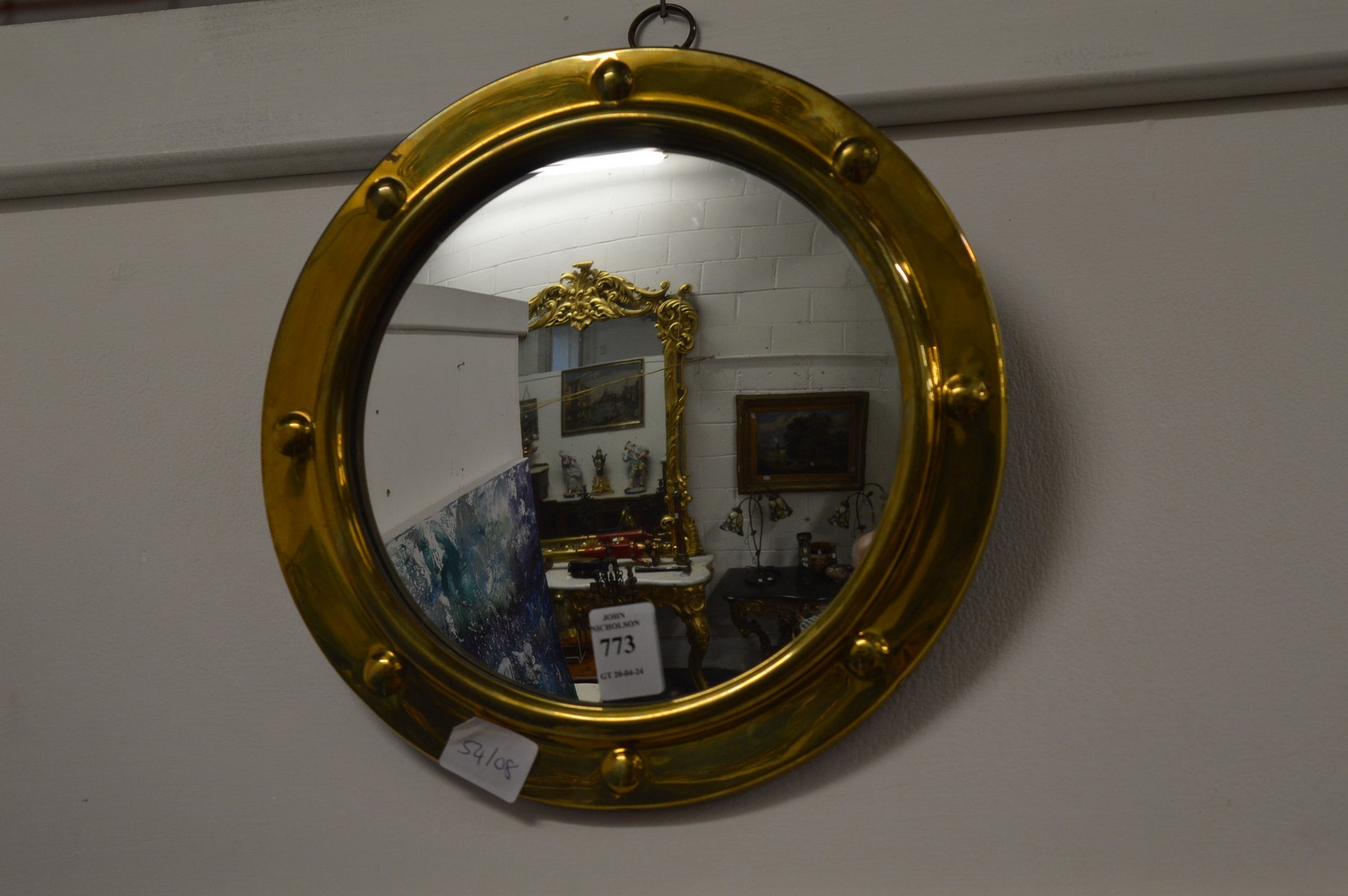 A small brass framed convex mirror.