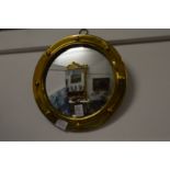 A small brass framed convex mirror.