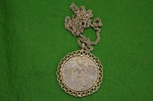 Silver chain with coin inset pendant.