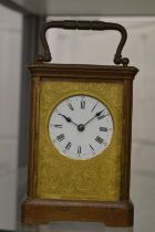 A brass carriage clock.