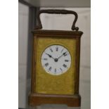 A brass carriage clock.