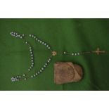 A rosary with turquoise beads.