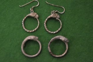 A group of silver snake decorated jewellery.