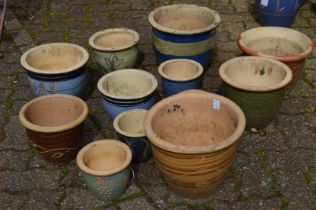 A quantity of glazed plant pots.