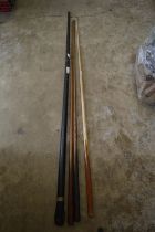 Three snooker cues and a black Japanned snooker cue case.
