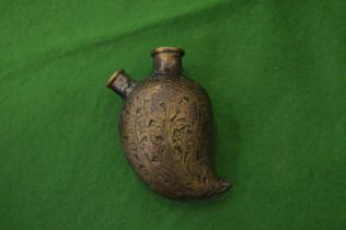 A small Eastern engraved brass bottle.