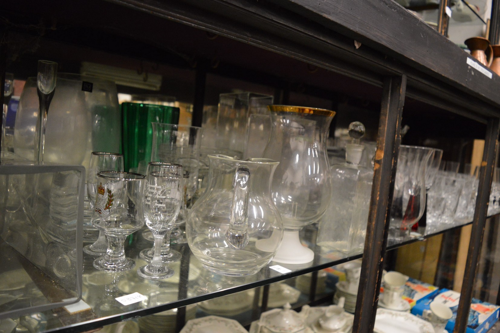 A large quantity of glassware to include numerous vases, drinking glasses etc.