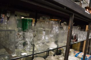 A large quantity of glassware to include numerous vases, drinking glasses etc.