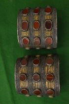 Two African white metal bangles inset with hard stones.