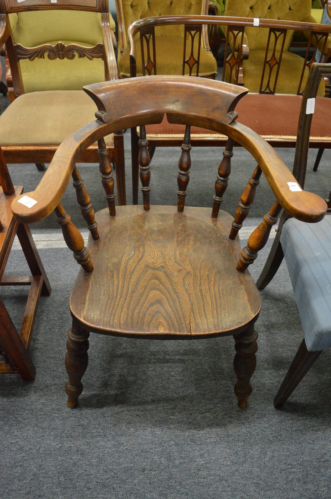 A 19th century beech and elm smokers bow armchair.