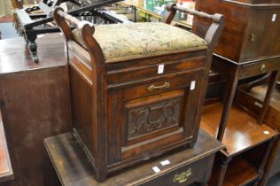 A Victorian walnut music seat.