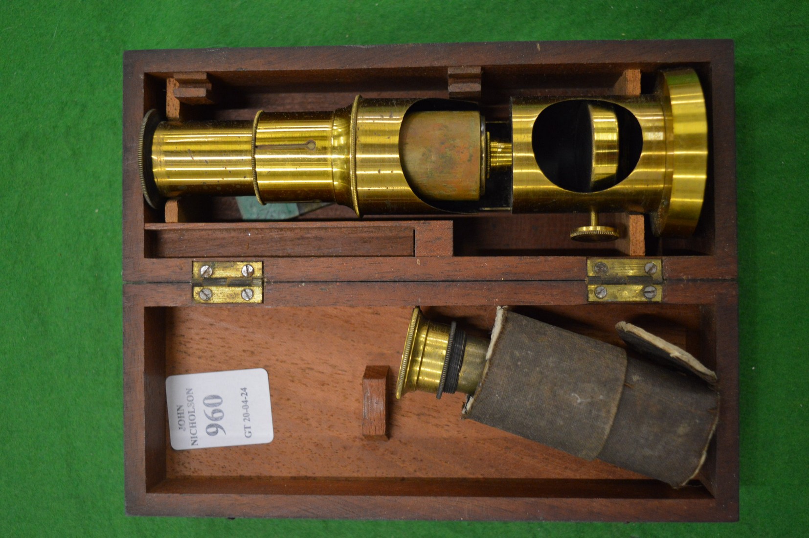 A small mahogany cased brass microscope.