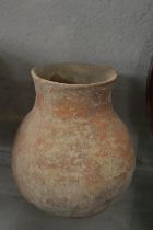 An early terracotta pottery bulbous shaped vessel.