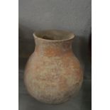 An early terracotta pottery bulbous shaped vessel.