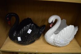 Two Dartmouth pottery swan shaped jardiniere's, one black, one white.