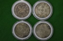 Four Chinese white metal disks with calligraphy decoration.