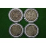 Four Chinese white metal disks with calligraphy decoration.