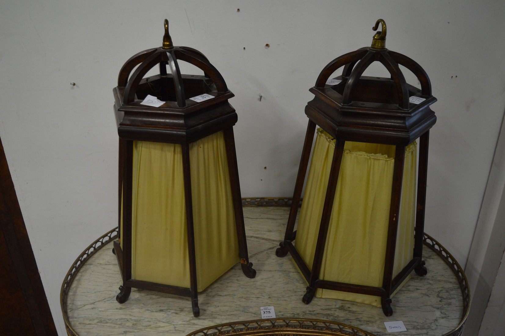 A pair of unusual mahogany and silk work hanging shades.