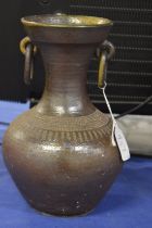 A salt glazed vessel with ring handles.