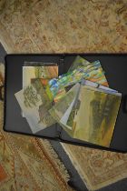 A case containing unframed oil paintings.