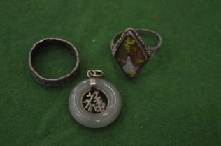 Two rings and a jade pendant.