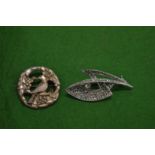 Two decorative brooches.