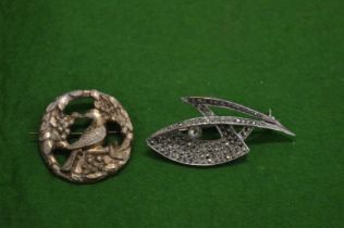 Two decorative brooches.